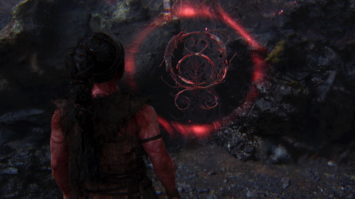 Red glowing rune symbols forming a gate barrier in Hellblade 2